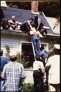 State troopers removing a handcuffed protester from the roof of the home of war tax resisters Randy Kehler and Betsy Corner