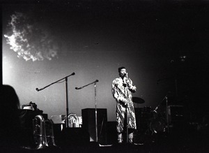 Taj Mahal in concert at Northfield, Mass.: Taj Mahal standing at microphone