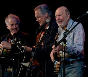 Pete Seeger performing on stage with Tom Chapin and David Amram (from right) at the Earth Day concert