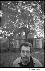 Unidentified man in front of a house