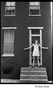 Karen Helberg, posed in a doorway to a brick house, York, Pa.