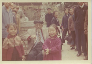 W. E. B. Du Bois sitting with two unidentified children at the Summer Palace in Beijing, China