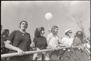 Antiwar demonstration at Fort Dix, N.J.: line of women protesters holding pipe, close-up