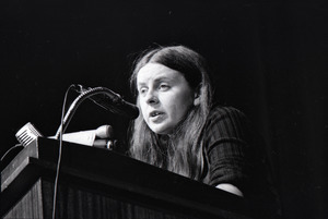 Bernadette Devlin McAliskey at the podium during a talk at Northeastern University