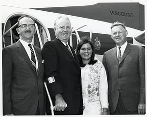 Unidentified man, Mayor John F. Collins, and daughter Patricia Collins in front of airplane in Saint John, New Brunswick, Canada, with Saint John Mayor Dr. Stephen H. Weyman