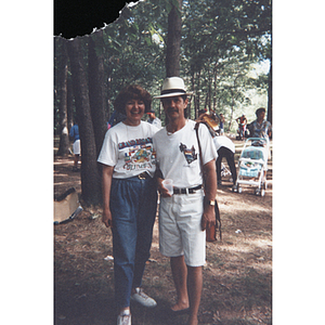 A man and a woman stand together at an outdoor picnic event