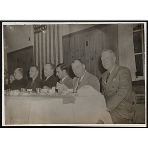 Several committee members seated at a banquet table