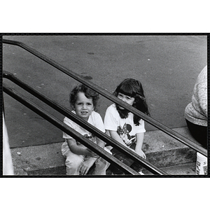 Two girls sitting on the stairs outside the Charlestown Boys and Girls Club building