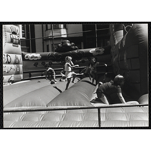 Children play on an inflatable at a carnival