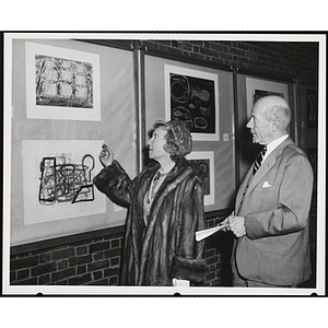 "Mr. John W. Valentine, Overseer, and Mrs. Valentine, view the Boys' Clubs of Boston's Art Exhibit at the Museum of Science"