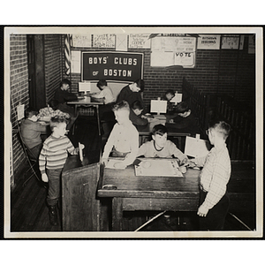 Boys fill out ballots and cast votes in an election