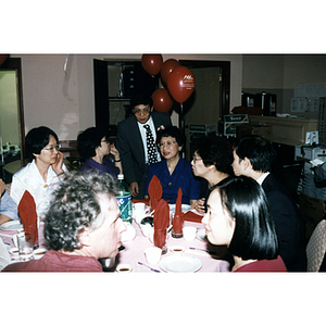 People sit at restaurant table during Chinese Progressive Association's 20th Anniversary Celebration