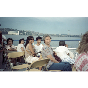 Suzanne Lee and other female Association members sit on the deck of a ferry