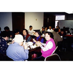 Members of the Chinese Progressive Association eat Thanksgiving dinner