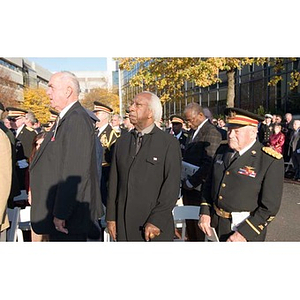 Three men stand at the Veterans Memorial dedication
