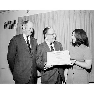 President Asa Knowles presents law degree to Kathleen Costello with Dean Philip Boyd looking on