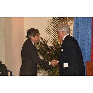 Senator Kennedy and Richard Freeland shake hands at press conference on student financial aid cuts