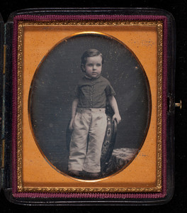 Boy standing on a chair