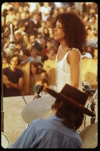 Jefferson Airplane performing at Woodstock: Grace Slick on stage, with audience in background