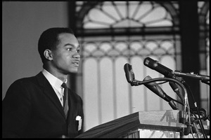 Walter E. Fauntroy speaking at a podium at the Youth, Non-Violence, and Social Change conference, Howard University
