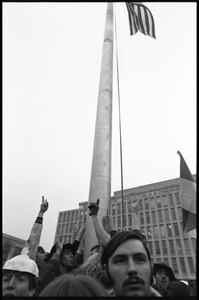 Anti-Vietnam War protesters gathered around the flagpole in front of the HEW Building, during the Counter-inaugural demonstrations, 1969