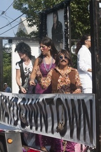 Parade marchers in 1960s attire, in front of a poster of Michael Jackson : Provincetown Carnival parade