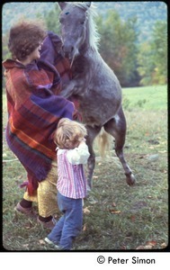 Woman and child with rearing horse, Tree Frog Farm Commune