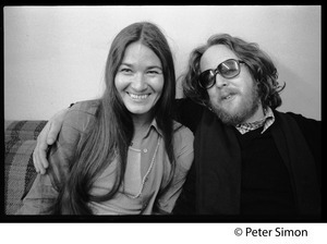 Keith Godchaux, seated on a couch with arm around Donna Godchaux