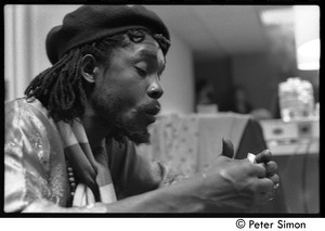 Peter Tosh rolling a marijuana cigarette backstage during his appearance on Saturday Night Live