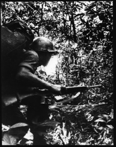 Teenage ARVN trooper running through the jungle