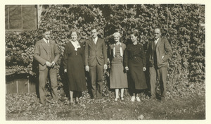 Library staff standing south of ivy covered Old Chapel building