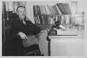 Colonel Richard Briggs Evans sitting indoors, behind desk
