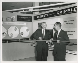 Two unidentified men cutting a ribbon in front of an ICD exhibit