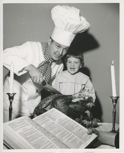 Leslee Trimble and chef with turkey and bible at Thanksgiving celebration