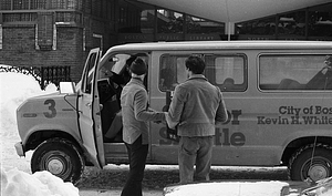 Unidentified men in front of city shuttle bus on Parameter Street