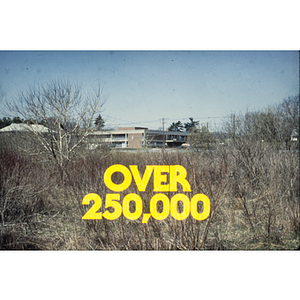 Advertisement reading, "over 25,000" featuring photo of the exterior of a building from across a field