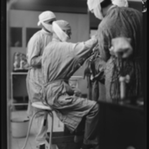 Harvey Cushing seated while working on the 2,000th tumor operation