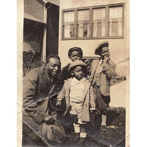 A man poses with three boys