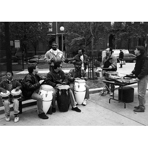 Latin Percussion group making music in a neighborhood park.