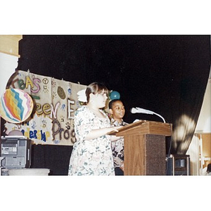 Boy and girl at the podium addressing the audience at a Teen Empowerment Program event.