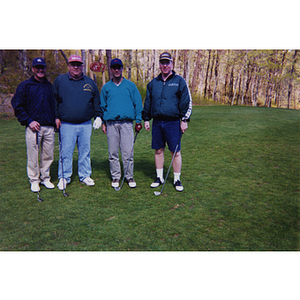 A four-man golf team posing at the Charlestown Boys and Girls Club Annual Golf Tournament