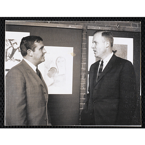 Frederick J. Davis, at left, and John U. Harris, Jr. converse at the Boys' Clubs of Boston Tri-Club Art Exhibit at the Museum of Science