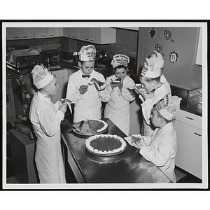 Members of the Tom Pappas Chefs' Club eat pie in the Shearton Plaza Hotel testing kitchen