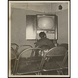 A Boy sitting in front of a television set