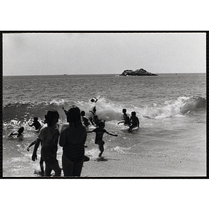 Children play in the surf at a beach