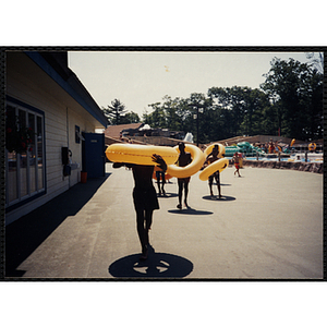 Boys carry intertubes at Water Country water park during a Tri-Club field trip