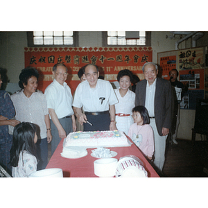 You King Yee cuts cake at a Chinese Progressive Association anniversary event