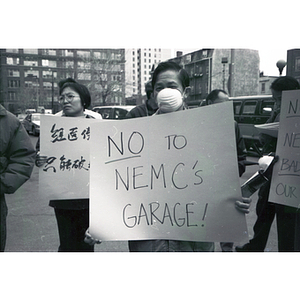 Protesters hold signs and demonstrate in the Oak Street parking lot (Parcel C in Chinatown)