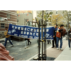 People marching a victory banner through Chinatown