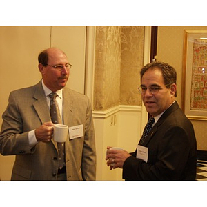 Abbot Gilman CBA '76, left, before College of Business Administration's CEO Breakfast Forum